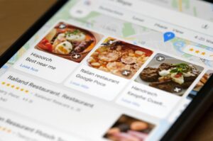 Close-up view of a mobile interface showing local restaurant search results, featuring high-quality food photography, Italian cuisine options, and star ratings.