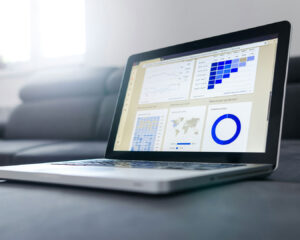 A laptop screen displaying charts and data visuals, suggesting analysis or business planning work.