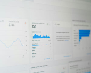 A computer screen displaying an SEO performance graph with rising trends, symbolising improved website traffic and search ranking.