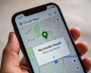 A close-up of a smartphone displaying Google Maps with a “Place not found” message on the screen, suggesting difficulty locating a destination or an unknown location.