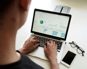 A man sits at a desk studying a data graph on his laptop, suggesting analysis, planning, or business decision-making.
Singapore’s F&B landscape is densely p