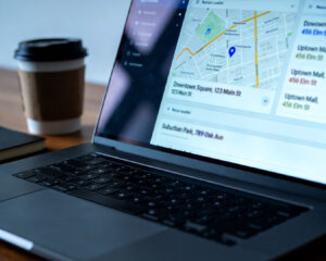 A laptop screen displaying multiple website listings with different business names, addresses, and phone numbers, illustrating inconsistent business information across various online platforms.