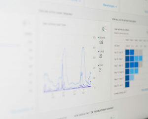 Close-up of a laptop screen displaying a rising graph and data charts, representing growth, performance, or digital analytics.