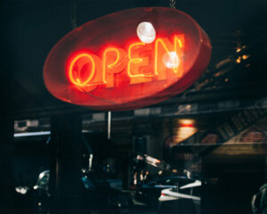 Shop opening signage displayed at the entrance, signalling the start of business operations and inviting customers inside.