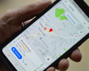A phone screen displaying Google Maps with a restaurant location pin, helping customers find directions easily.