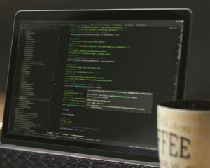 A laptop screen displaying website source code and error lines, representing technical website issues affecting performance and search ranking.